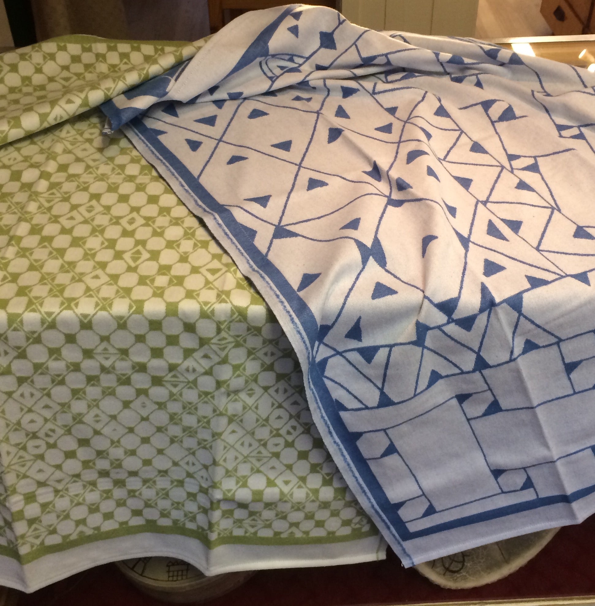 Barnfilt Marsfjällsnåjdens mönster i Doris och Sven-Åke Risfjells design,Risfjells Sameslöjd i Vilhelmina, södra Lappland. Ett gammalt mönster som upptäckts och återbördats av Sven-Åke Risfjell. Här en pläd i blått och en i grönt.