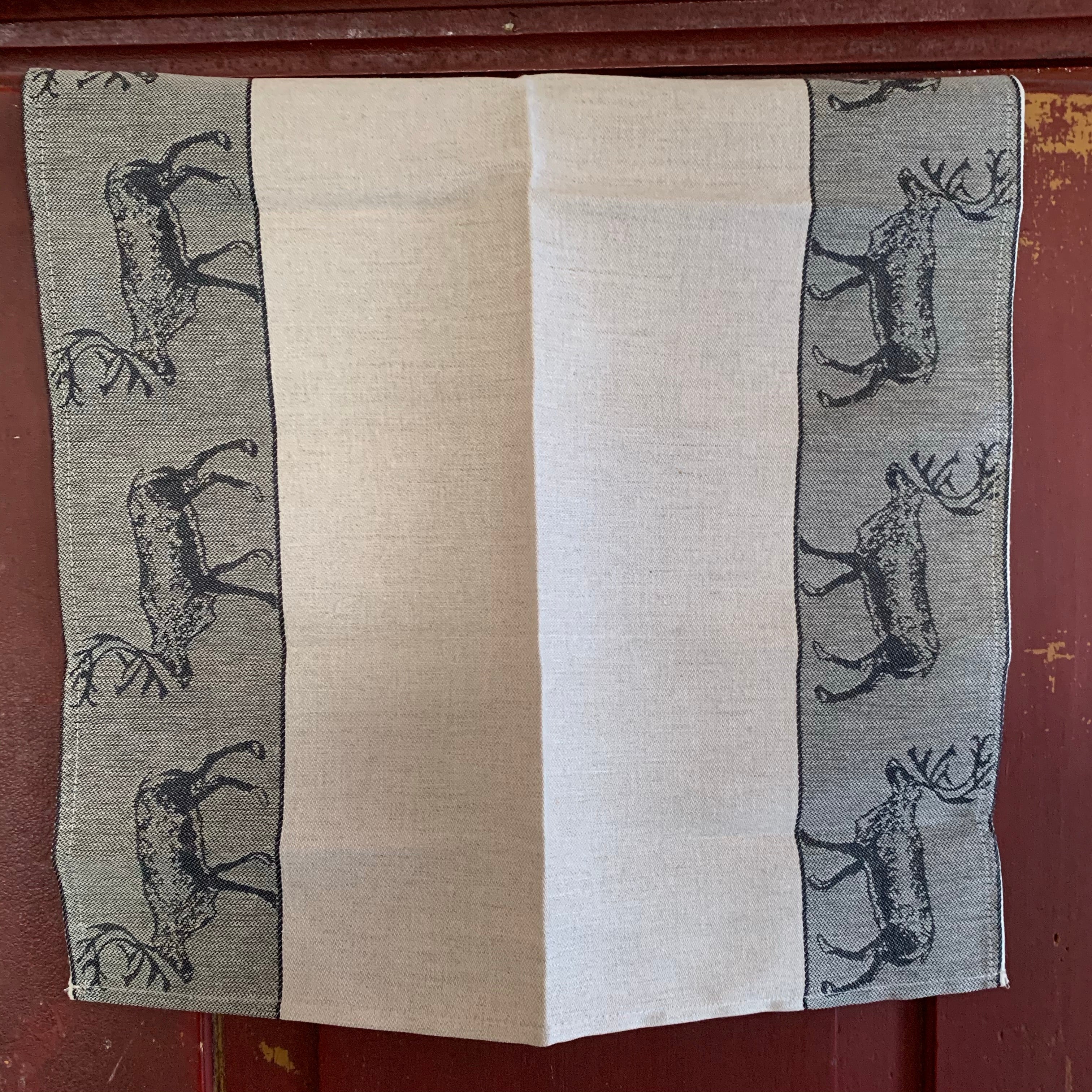 Från vår present och hemslöjdsavdelning Handduk i lin och bomull med linfärg i mitten och bårder i rött eller svart med invävda motiv av ren. Längd 70 cm. Bredd 47 cm. Här i svart.